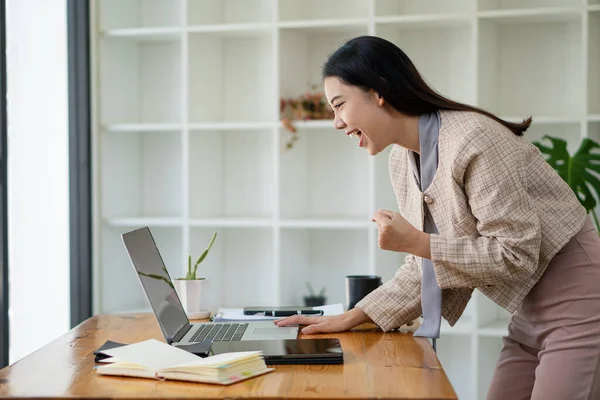 Asian woman working in office with laptop and tablet online working concept