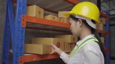 female worker checking goods in warehouse for delivery
