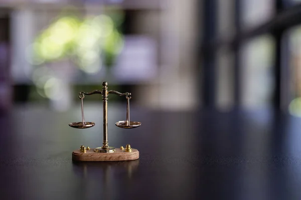 The scales of injustice, the hammer of the law tiger skin judges on the table in the conceptual law office.