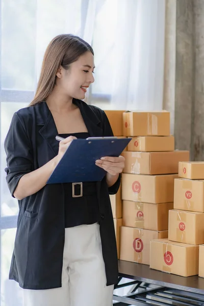 Starting small businesses SME owners female entrepreneurs Write the address on receipt box and check online orders to prepare to pack the boxes, sell to customers, sme business ideas online.