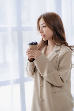 Ofiste dizüstü bilgisayar kullanan Asyalı bir kadın muhasebe analizi hazırlıyor emlak yatırım bilgileri vergi bilgileri ve finansal sistemler dikey resim