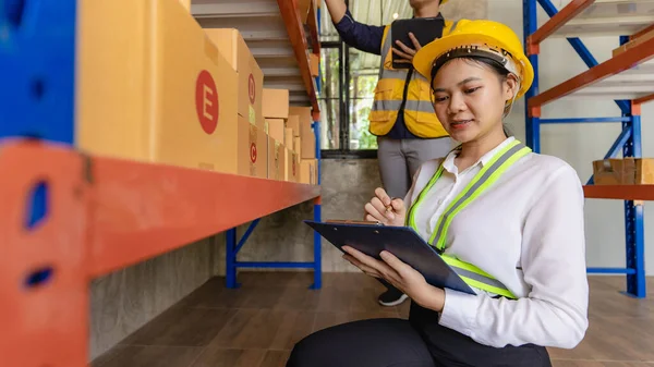 man, woman, asia, helmet, safety, employee, check, order, shelves, shipping, manager, storage, factory, industries, carrying, boxes, logistics, goods, supervisor, engineer delivery concept