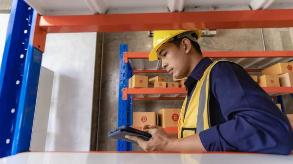Asian man managing warehouse worker man holding tablet in warehouse Logistics network distribution and intelligent logistics, import, export, and industrial concepts..box transport