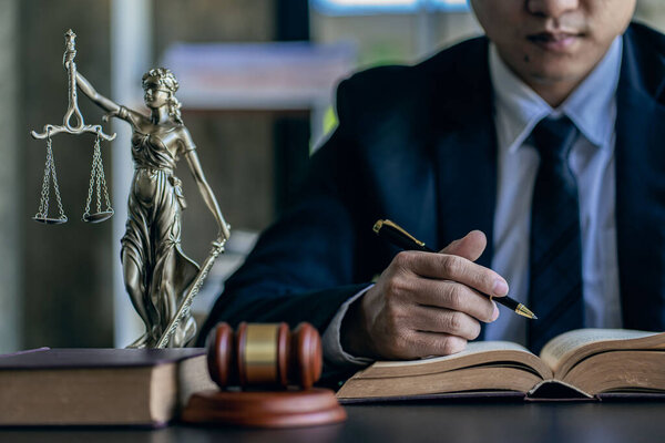 concept of justice and law Asian male judge in courtroom on table and counselormiddle-aged male lawyer working on documents, contracts, law, justice