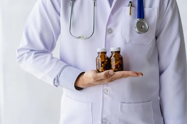 Your doctor will write you a prescription and will be available to give you instructions on how to use it.Close-up of pills opposite a female doctor sitting at a hospital table.