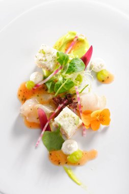 Fine dining, Elegant seabass tartare with avocado and pesto topped balsamic sauce