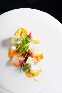 Fine dining, Elegant seabass tartare with avocado and pesto topped balsamic sauce