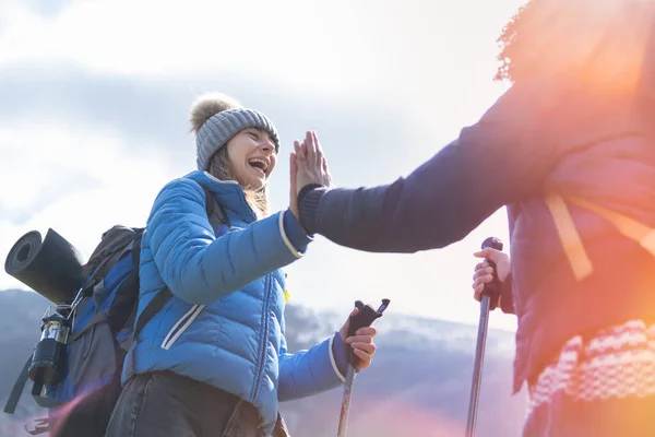 Give me five. Joyful satisfied funny hikers holding hands up smiling and gesticulating - Discovery Travel Destination Concept