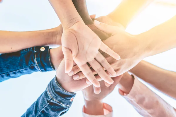 Close up view of young business people putting their hands together - Stack of hand - Unity and teamwork concept - Selective focus