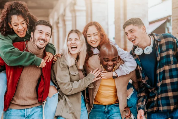 Multiracial young people walking happily on the street - Guys and girls having fun together - Lifestyle concept - Selective focus