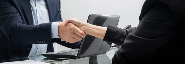 Business people handshake in the office after meeting - Successful business man and business woman handshaking after good deal. Partnership meeting concept