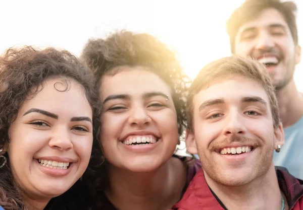 Multiracial group of young hipster friends make selfie photo with smartphone - Happy life style concept with young students having fun together - Selective focus