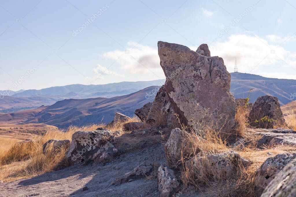 Standing stones in Zorats-Karer or Karahunj. Ancient megalithic complex, on a mountain plateau at an altitude of 1770 meters above sea level, Syunik region of Armenia. Historical and cultural reserve