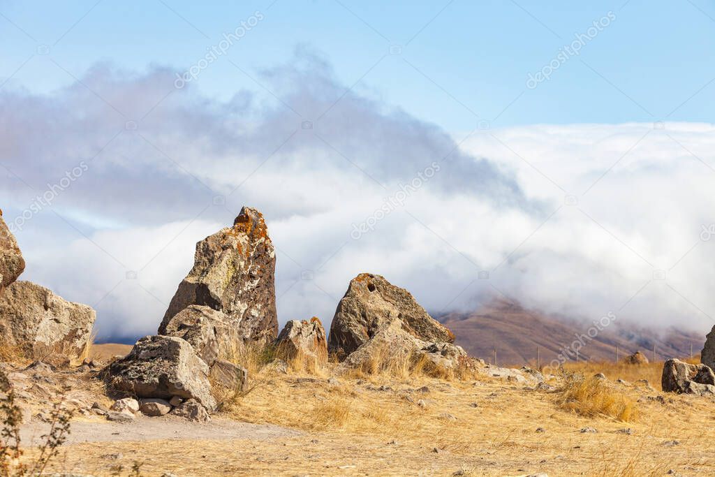 Standing stones in Zorats-Karer or Karahunj. Ancient megalithic complex, on a mountain plateau at an altitude of 1770 meters above sea level, Syunik region of Armenia. Historical and cultural reserve