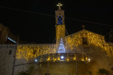 light decorations and christmas trees during new year celebration in Nazareth city in 2021