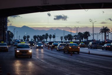Izmir, Turkey, 4th of January 2022 - Cars - Vehicles passing on the Mustafa Nemal Sahil Boulevard during sunset