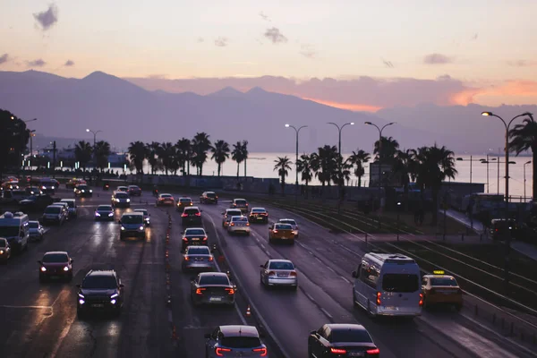 Izmir, Turkey, 4th of January 2022 - Cars - Vehicles passing on the Mustafa Nemal Sahil Boulevard during sunset