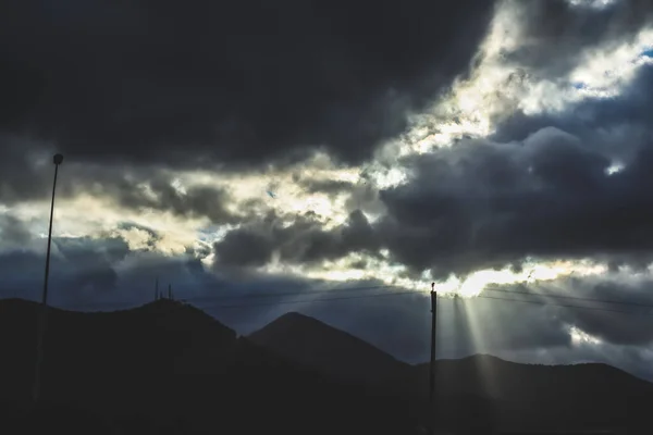 Landscape of surrounding mountains with sunray striking through clouds in Izmir, Turkey
