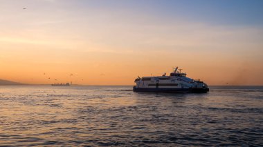 Izmir, Turkey, 4th of January 2022 - Ship on the Aegean Sea during sunset on the coast of Izmir with copy space