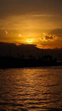 Sunset over the mountains and the coast - bay of Aegean Sea in Izmir, Turkey with copy space