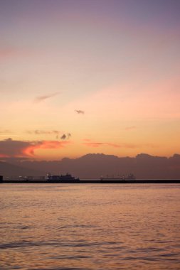 Sunset over the mountains and the coast - bay of Aegean Sea in Izmir, Turkey with copy space