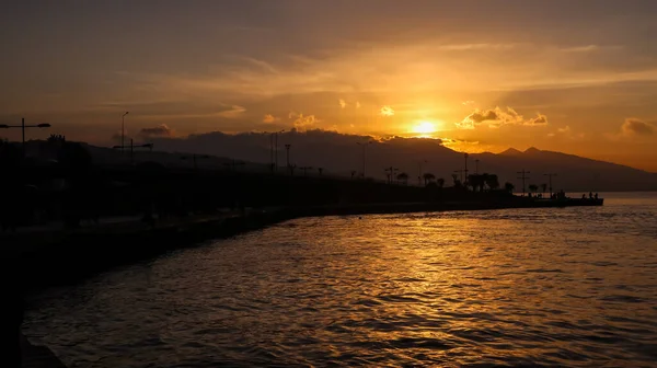 Sunset over the mountains and the coast - bay of Aegean Sea in Izmir, Turkey with copy space