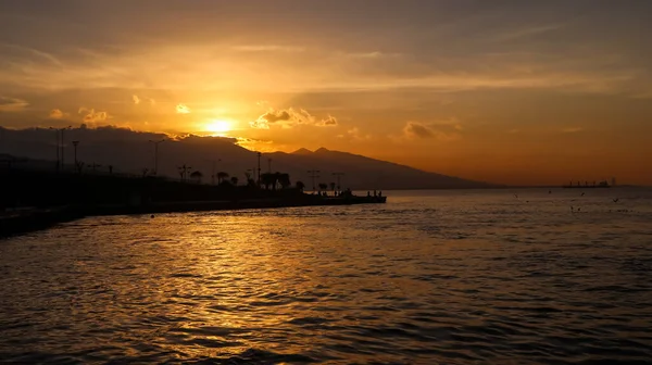 Sunset over the mountains and the coast - bay of Aegean Sea in Izmir, Turkey with copy space