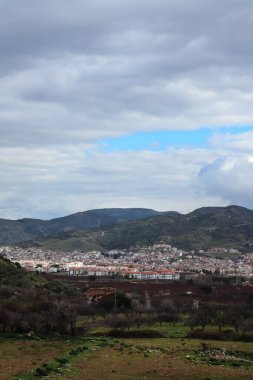Cityscape - Landscape of Selcuk city near Ephesus enlightened by sun with mountains in the distance