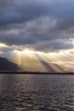 Mountains and the Aegean Sea on the coast of Izmir with copy space and sunrays
