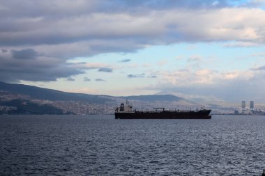 Izmir, Turkey, 5th of January 2022 - Ship on the Aegean Sea during sunset on the coast of Izmir with copy space