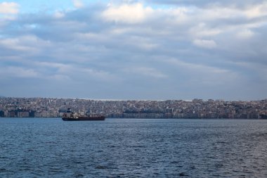 Izmir, Turkey, 5th of January 2022 - Ship on the Aegean Sea during sunset on the coast of Izmir with copy space