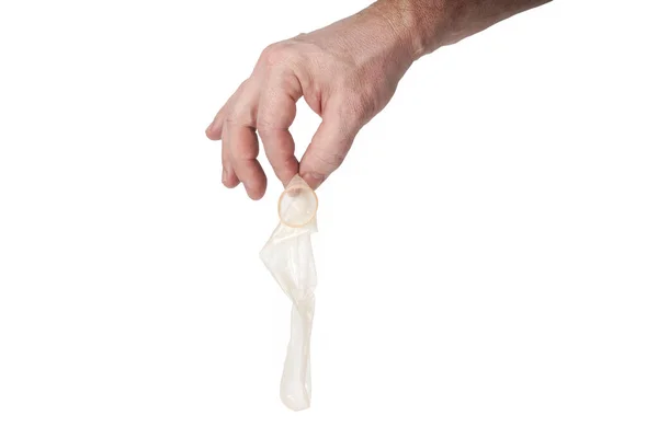 Hand holds a condom on a white background — Stock Photo, Image