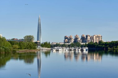Skyscraper of Gazprom in St. Petersburg with fucking in river against background of a blue sky, cityscape on summer sunny day