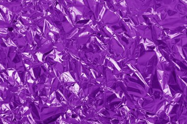 Mor metalik folyo parlak doku, arkaplan ve tasarım çalışmaları için buruşuk ambalaj kağıdı.