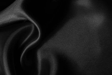 Arkaplan ve tasarım için siyah kumaş dokusu, güzel buruşmuş ipek ya da keten deseni..