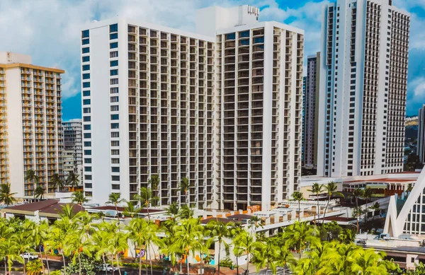 A photography of Big buildings near beach with sunshine.