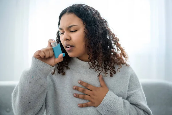 Black woman taking her inhaler at home at the living room — Stock Photo, Image