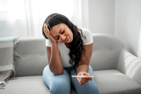 Unhappy Black Woman Looking Pregnancy Test Upset Result Sitting Couch — Fotografia de Stock