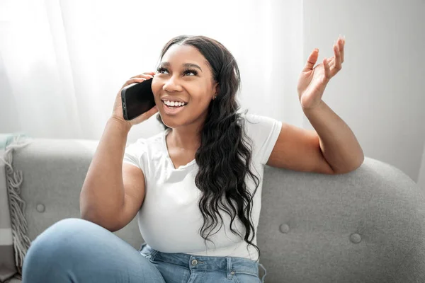 Expresive Young African Woman Sitting Couch Home Cellphone — Stock Photo, Image