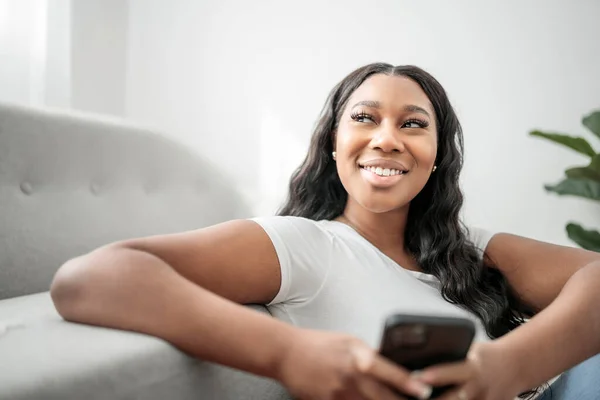 Attractive Young African Woman Sitting Couch Home Cellphone — Stock Photo, Image
