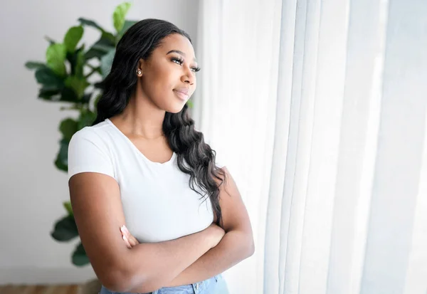 African American Woman Looking Aside Out Window Standing Home — Stockfoto