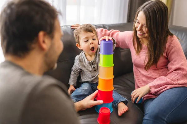 Family and little two years old boy playing together with toy at home. — Fotografia de Stock