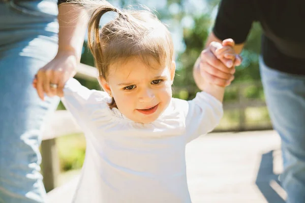 Two years child girl in forest holding parents hand — Stock Photo, Image