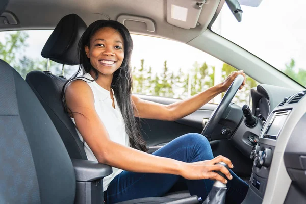 Black woman driver seated in her new car — Photo