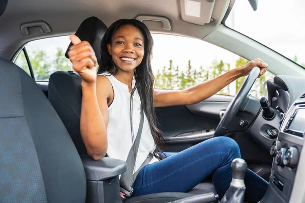 Black woman driver seated in her new car — Photo
