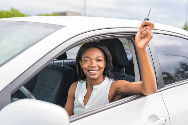 Black woman driver seated in her new car — Photo