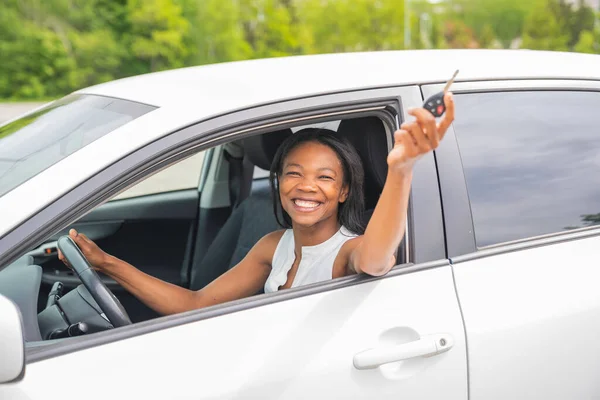 Black woman driver seated in her new car — Photo