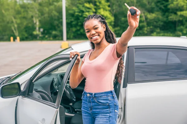 Young black teenage driver seated in her new car — Photo