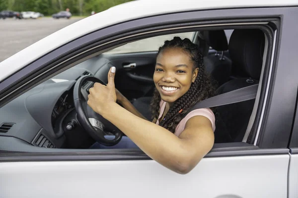 Young black teenage driver seated in her new car — Photo