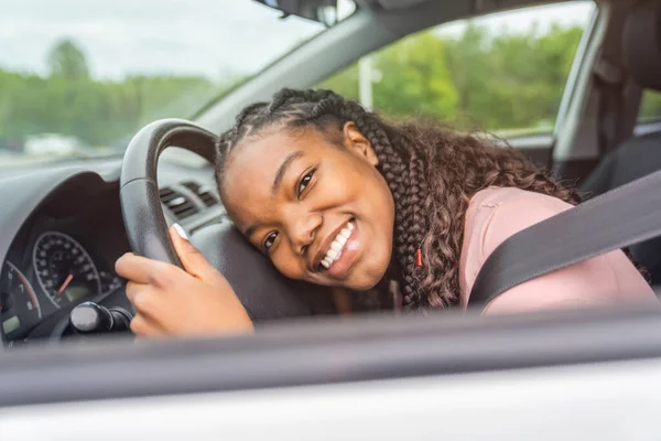 Young black teenage driver seated in her new car — Photo